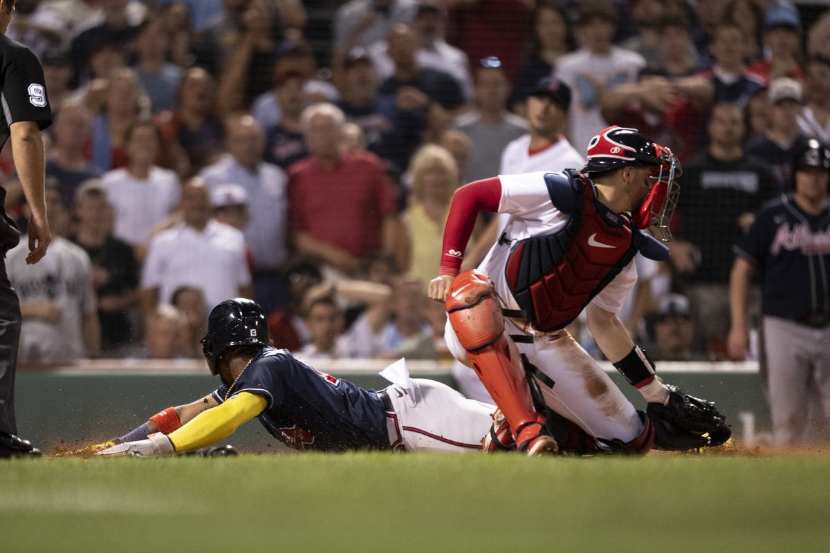 Ronald Acuna Jr. slides home for the insured run in the top of the 11th inning