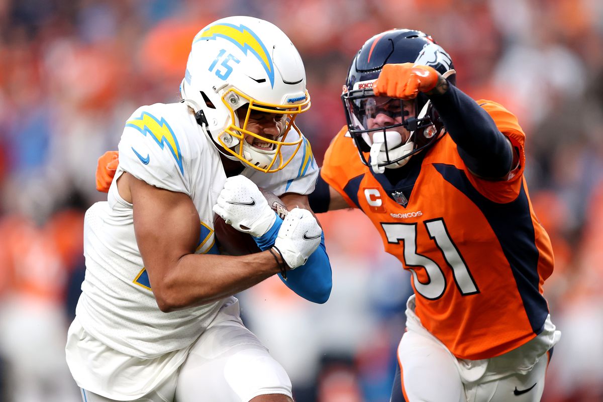 Chargers receiver Jalen Guyton tries to elude a receiver